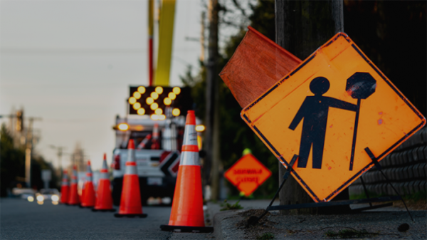 A row of small orange cones on the side of the road